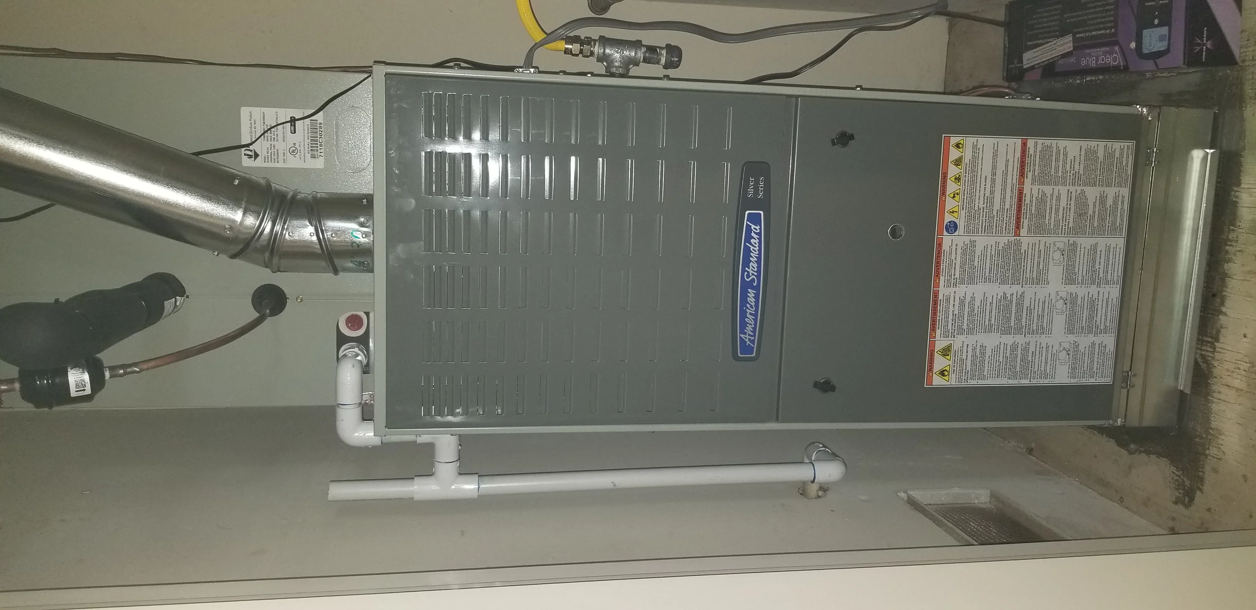 American Standard furnace installation with ductwork and gas line connections